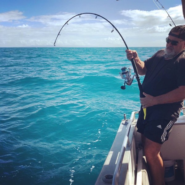 a person standing next to a body of water