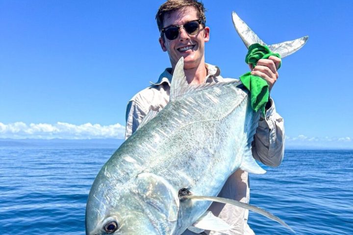 a man holding a fish in the water