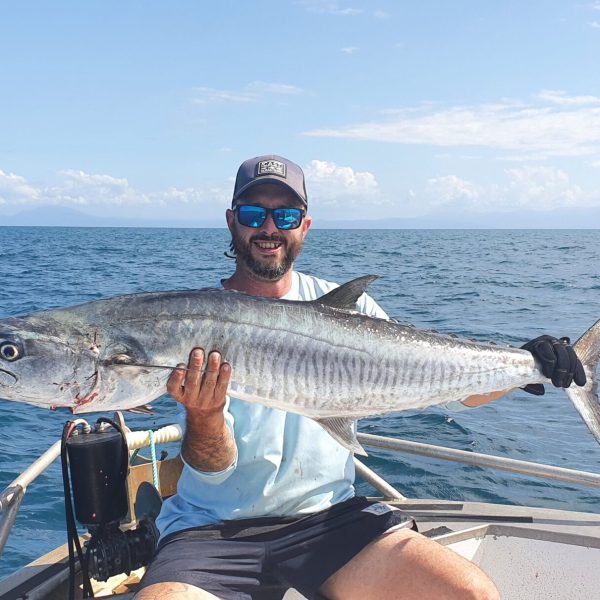a person holding a fish in the water