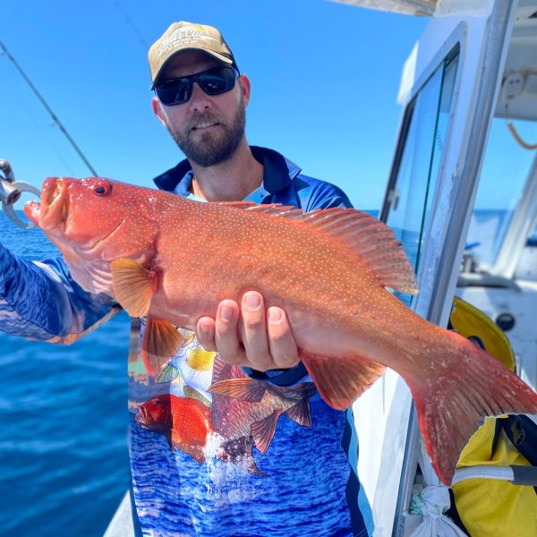 a man holding a fish