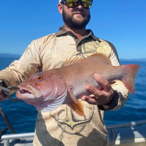 a man holding a fish