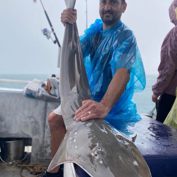 a person holding a fish