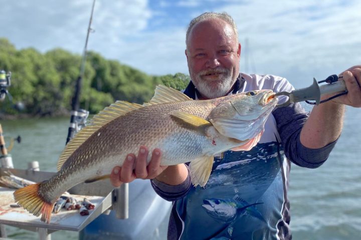 a man holding a fish