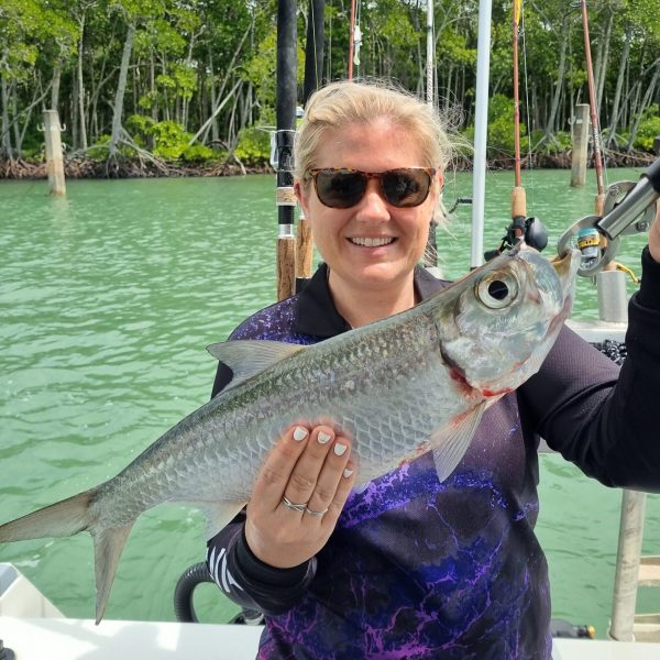 a person holding a fish in the water