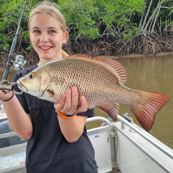 a person holding a fish in the water